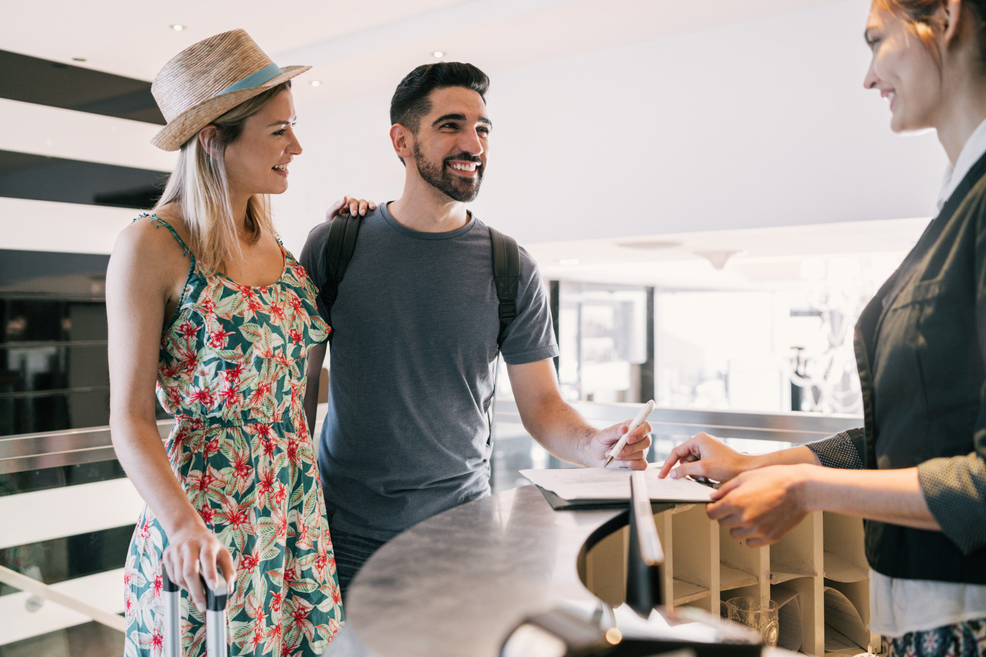 couple-doing-check-in-at-hotel-reception-front-desk