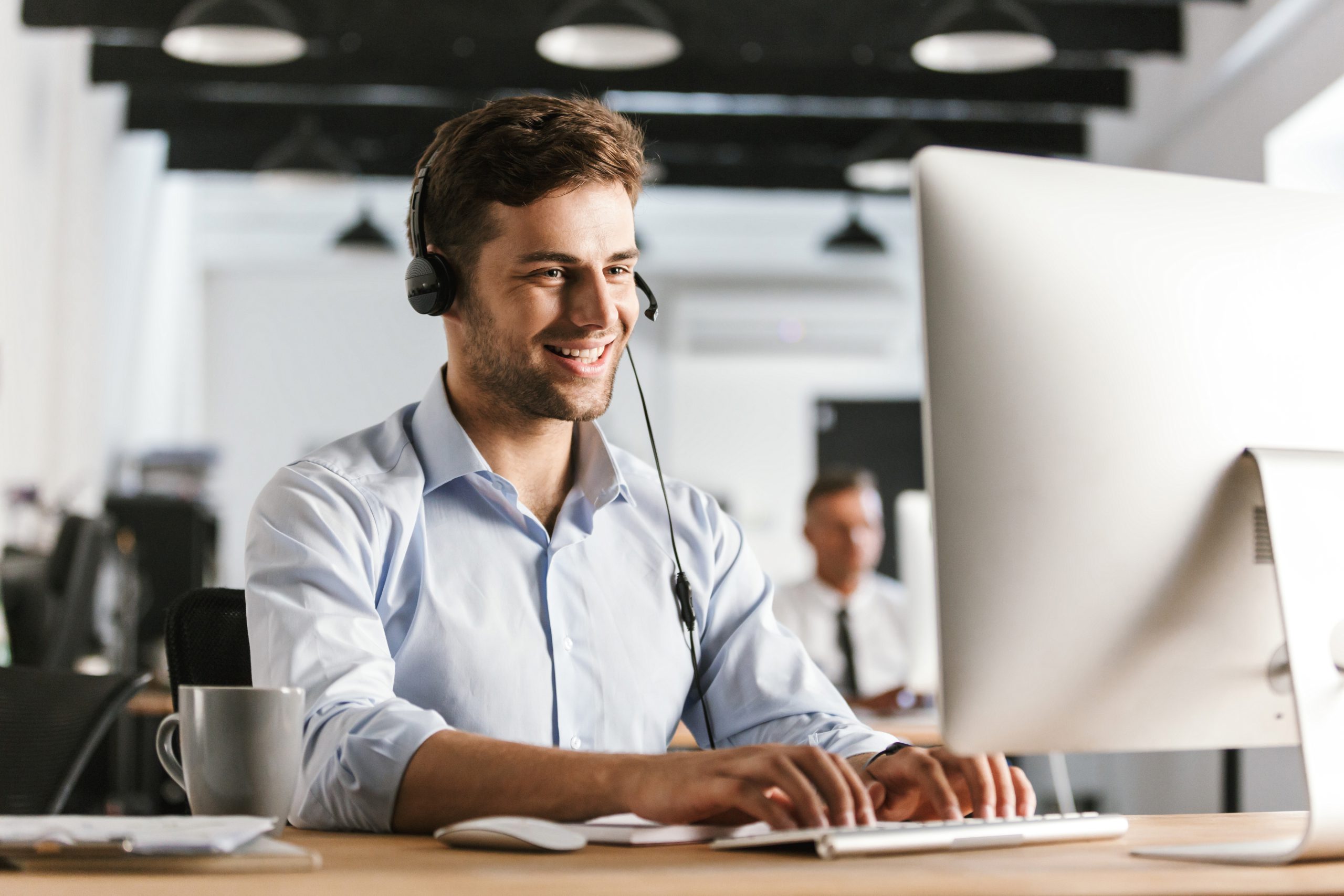 Photo of businesslike man 20s wearing office clothes and headset