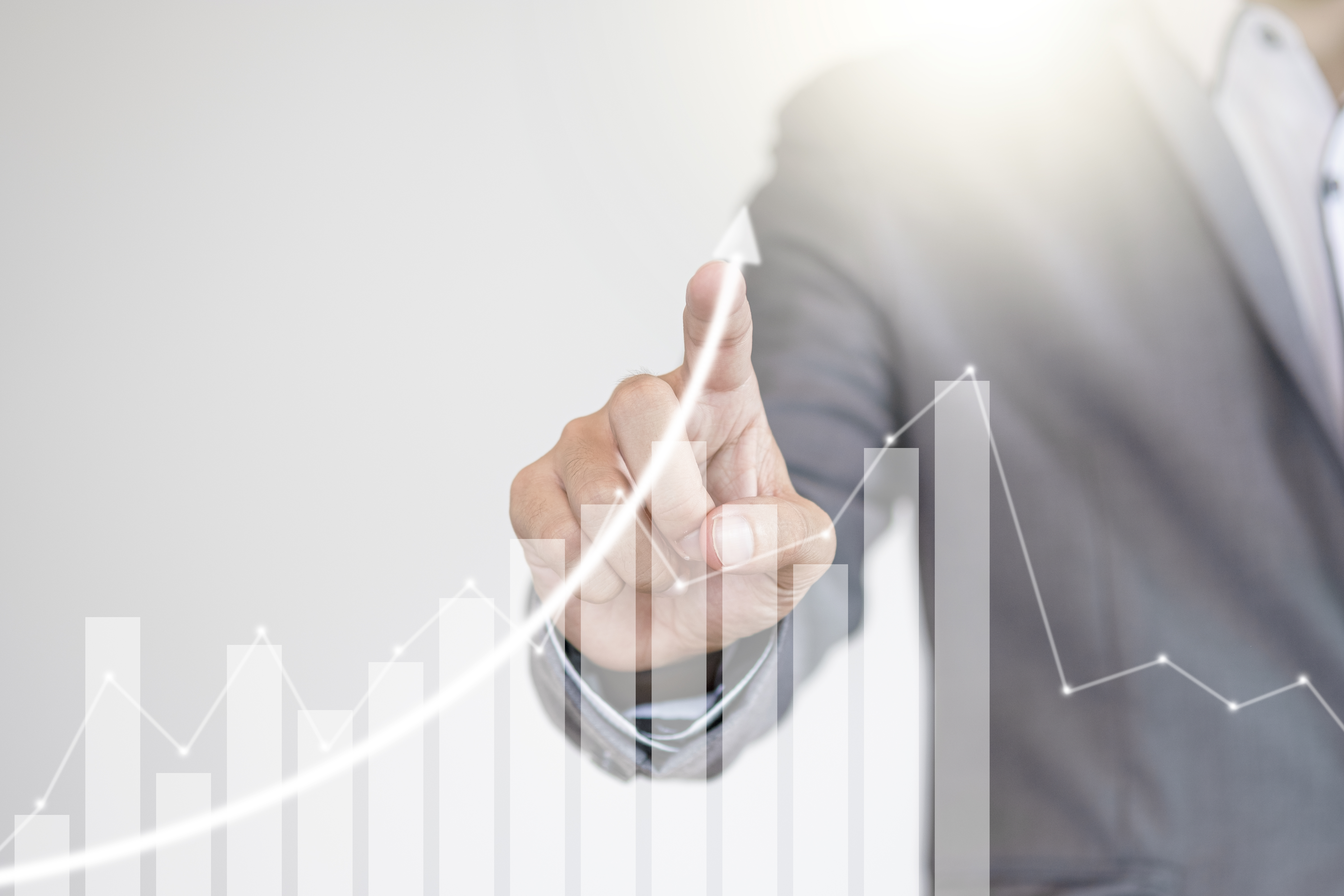 Fund manager hand writing increasing graph to screen monitor. In